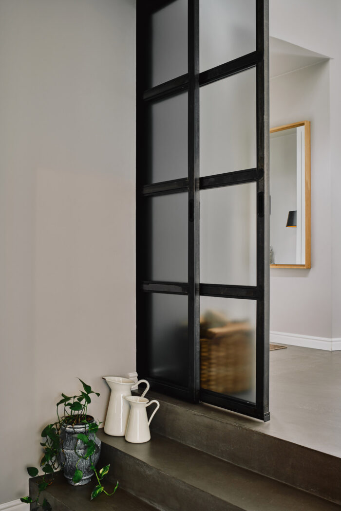 Minimalist interior decoration with black sliding door and milk jar