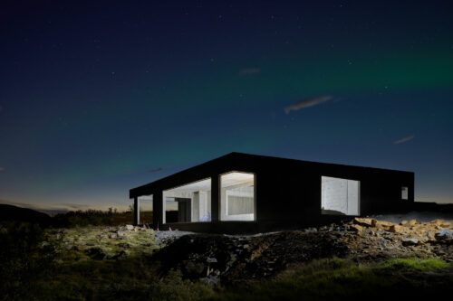 Concrete house in Iceland with northern lights and night photography