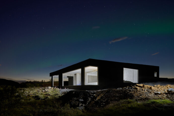 Concrete house in Iceland with northern lights and night photography