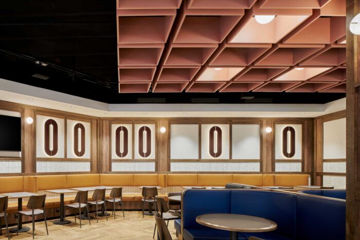 Pink boxed ceiling with mustard and blue leather seats