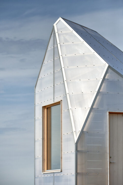 Cabin made of shiny plexiglass with large windows