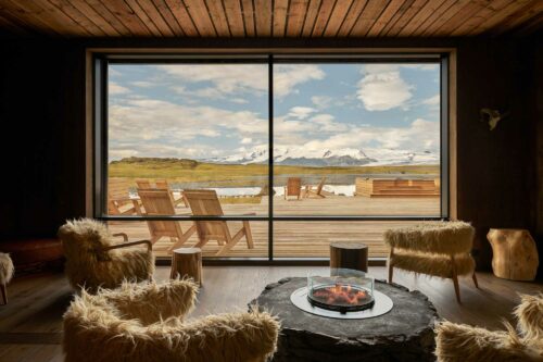 Lounge area in luxury hotel with large windows overlooking the glacier