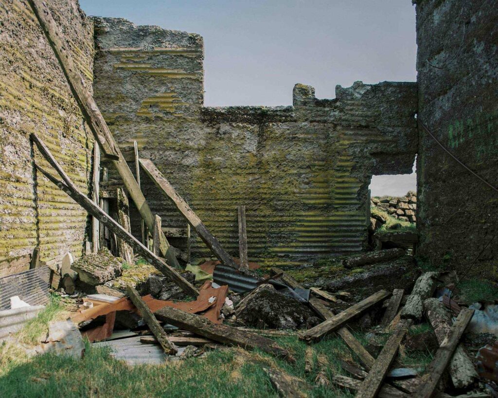 Concrete house in ruins with broken wooden inside in south of Iceland