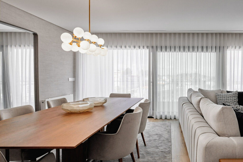 Modern living room with large windows bright interior and wooden table in Braga, Portugal