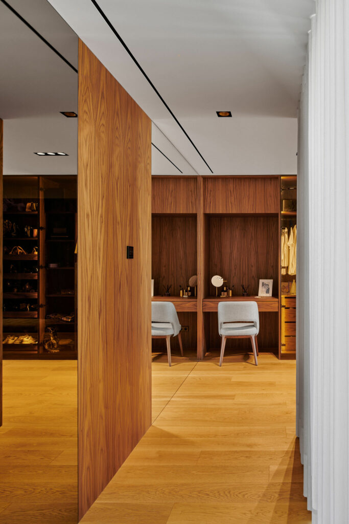 Interior corridor of a house with wooden floors and make-up desk