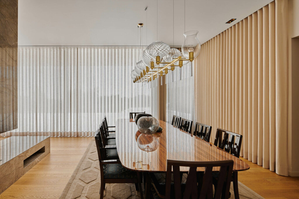 Luxury interior design of dining area with large table and bright windows