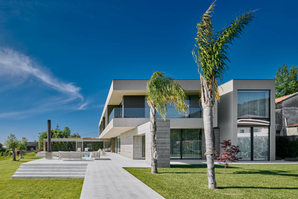 High-end villa with large windows palm trees and big pool