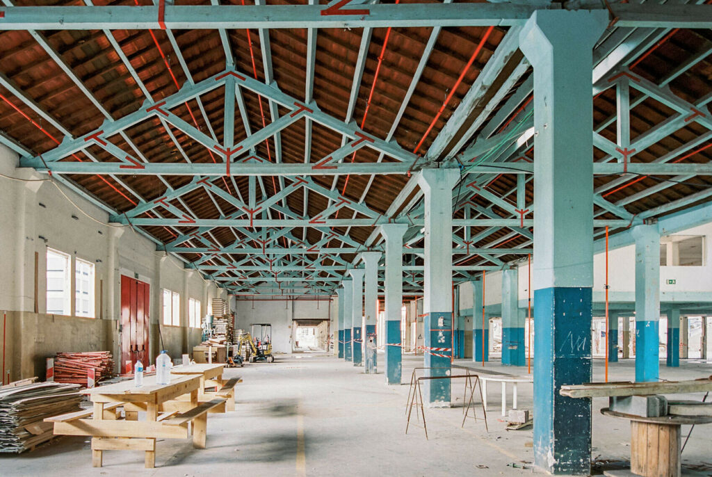 interior of a warehouse with blue columns and beams and red roof