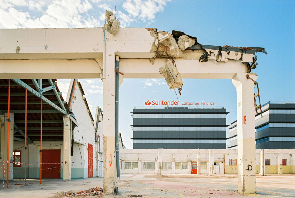 Demolished building with modern architecture construction in the background