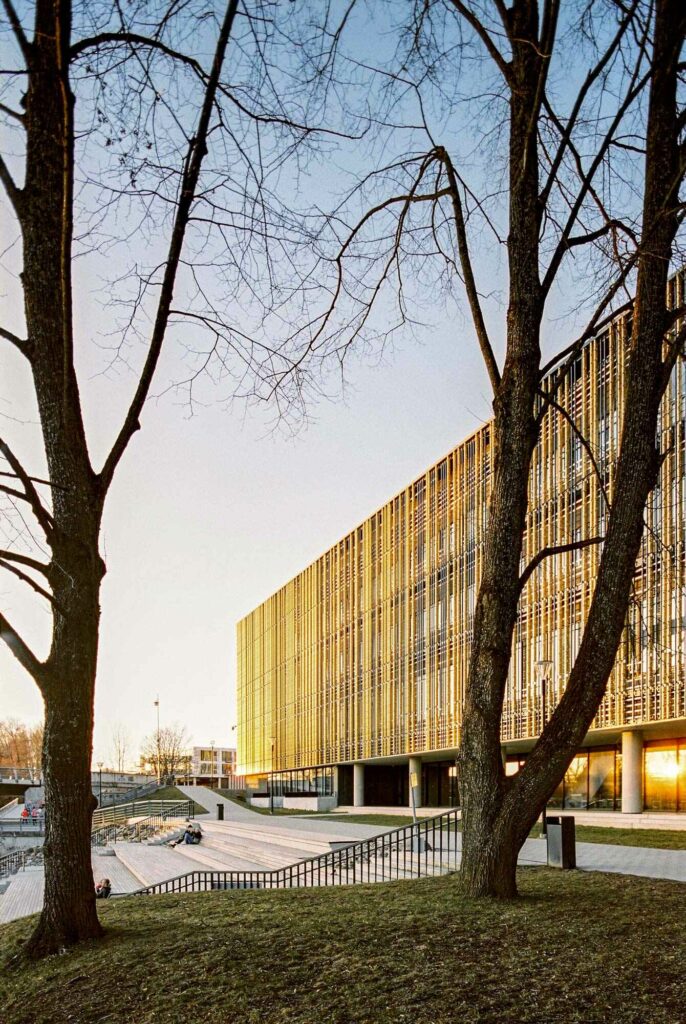 Golden façade building in between trees in Tartu, Estonia