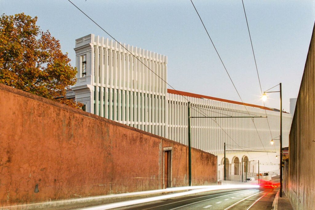 Modern architecture white building with concrete old walls and long exposure cars driving