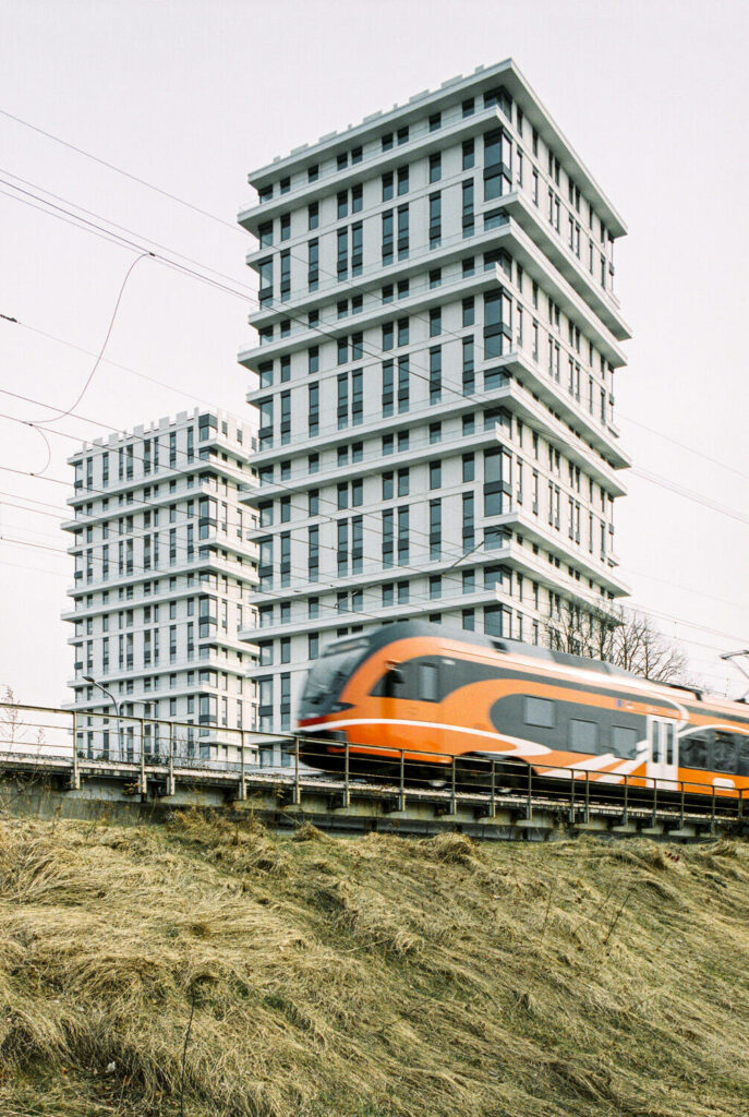 Modern architecture twin towers in Tallinn, Estonia and orange train passing by