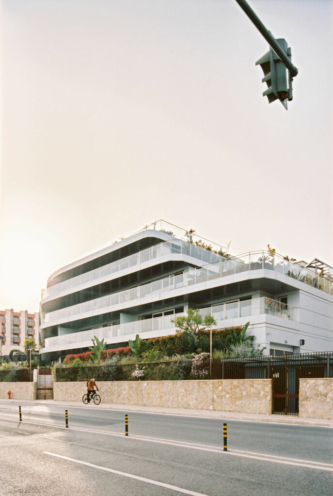 Modern building in Cascais, Portugal with large balconies and green terraces