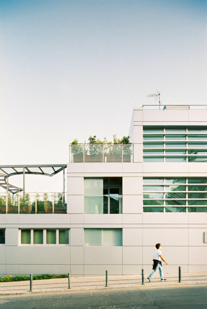 Metal façade building in Cascais, Portugal with large windows and green terraces