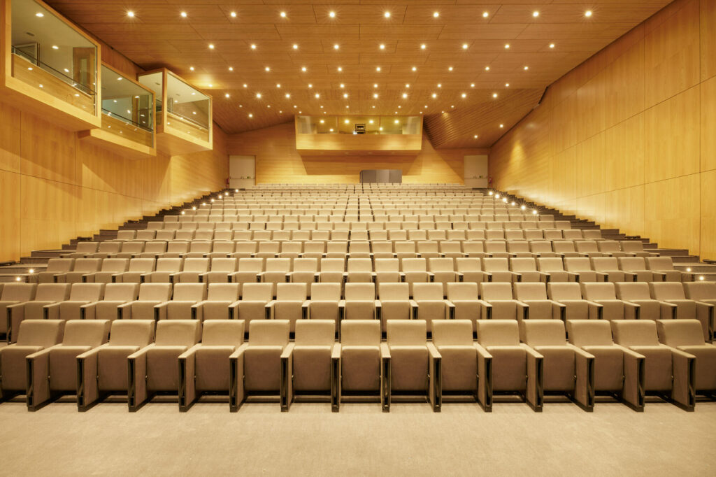 Auditorium with wooden walls and ceiling and large amount of seats