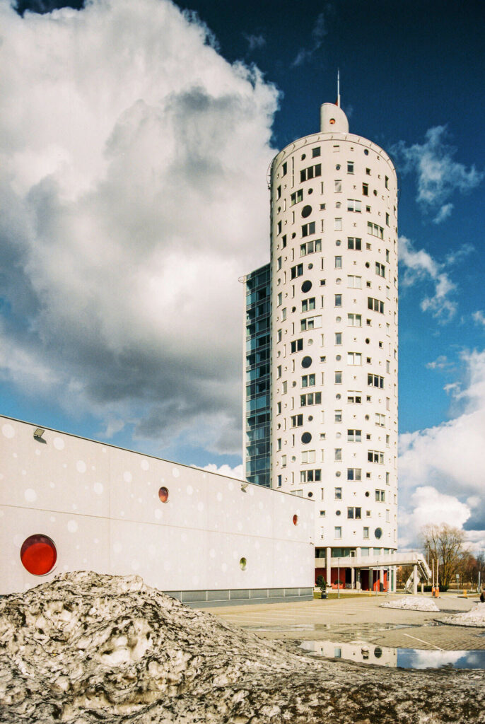 Modern architecture white tower with multiple windows and large white wall